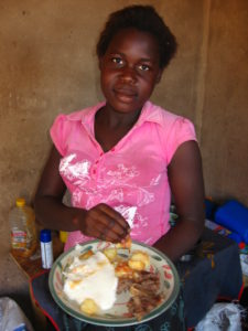 A girl eating typical Shangaan food