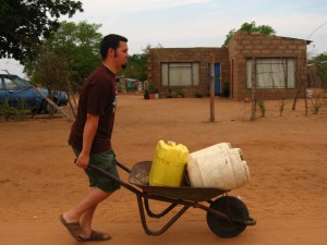 Adam pushing water in our wheelbarrow