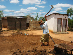 Adam hoeing our garden