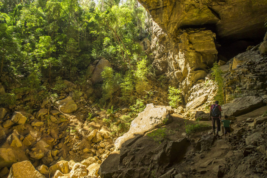 Matimu hiking out of a large cave in the Ankarana national park. It's one of the caves where Antakarana people used to bury some of their ancestors.