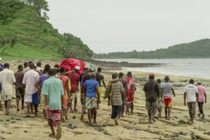 Walking along the beach with the guys carrying the body to the gravesite.